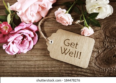 Get well message tag with roses wooden table - Shutterstock ID 184478276