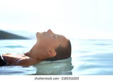 Getaway. Relax and rest concept. Profile Beauty portrait of Young attractive female model with  swimming in the transparent sea  water. Natural skin care - Powered by Shutterstock