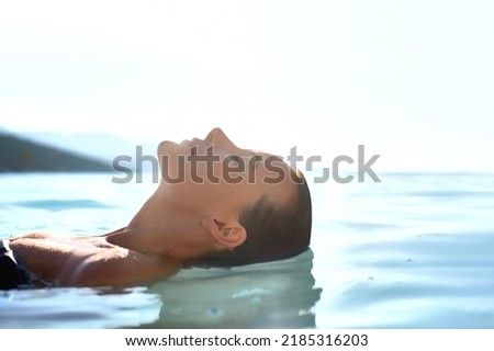 Getaway. Relax and rest concept. Profile Beauty portrait of Young attractive female model with  swimming in the transparent sea  water. Natural skin care