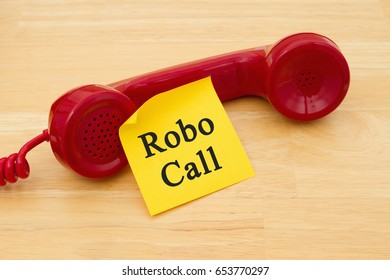 Getting A Call From A Robocall, Retro Red Phone Handset With A Yellow Sticky Note And Text Robocall