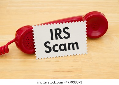 Getting A Call That Is An IRS Scam, A Retro Red Phone With Note Card On A Desk With Text IRS Scam