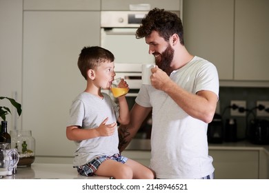 Getting the day started with his favourite little guy. Shot of an adorable little boy and his father having coffee and juice together at home. - Powered by Shutterstock