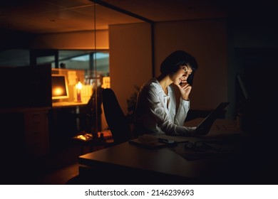 Getting it done after dark. Shot of a young businesswoman using a digital tablet during a late night at work. - Powered by Shutterstock