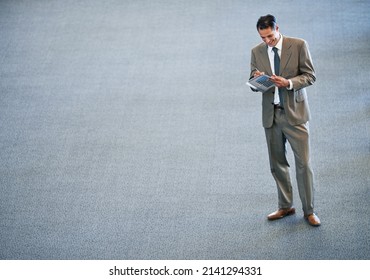 Getting Down To Buisness. Full Length Shot Of A Businessman Standing In A Lobby.