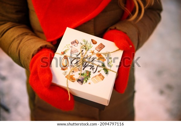 Getting dream desirable present from santa on
Christmas concept. Top above overhead close up view photo of woman
female hands in red mittens on the street in the eveningholding
small beautiful little