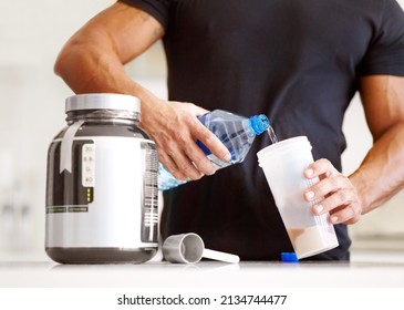 Getting enough protein in your diet. Cropped image of a bodybuilder making himself a protein shake.
