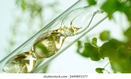 Getting essential oil from natural substances and flowers. Yellow oil flows in a spiral. - Powered by Shutterstock