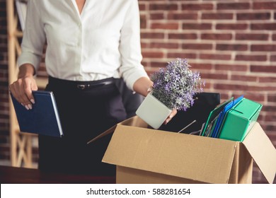 Getting Fired. Cropped Image Of Beautiful Young Business Woman In Formal Wear Packing Her Stuff Into The Box