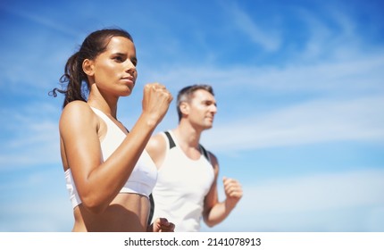 Getting Fit Together. Shot Of Two People Running Outdoors.