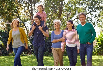 Getting the generations together. Shot of a happy multi-generational family walking together outside. - Shutterstock ID 2167992063