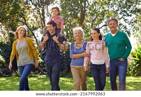 Getting the generations together. Shot of a happy multi-generational family walking together outside.