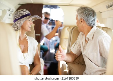 Getting The Go-ahead. Mature Couple Talking To The Pilot While On A Private Jet And Headed On A Trip.