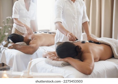 Getting good circulation going with some hot stone massage. a mature couple enjoying a hot stone treatment. - Powered by Shutterstock