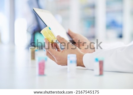 Getting his training online. A pharmacist working on a digital tablet.