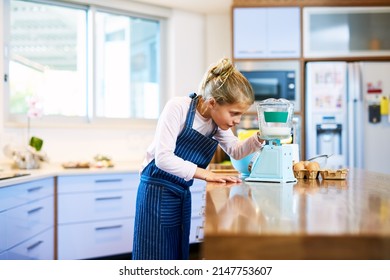 Getting The Ingredients To The Exact Measurement. Cropped Shot Of A Little Girl Measuring Ingredients On A Scale While Baking At Home.