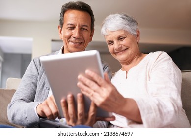 Getting to know the world of technology. A senior couple using a digital at home.