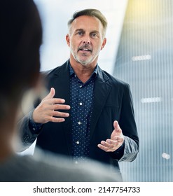 Getting My Team Up To Speed. Shot Of A Businessman Giving His Staff A Training Seminar.