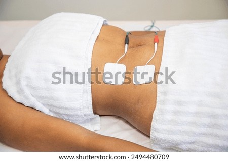 Getting myostimulation procedure of abdominal area for reducing excess weight
