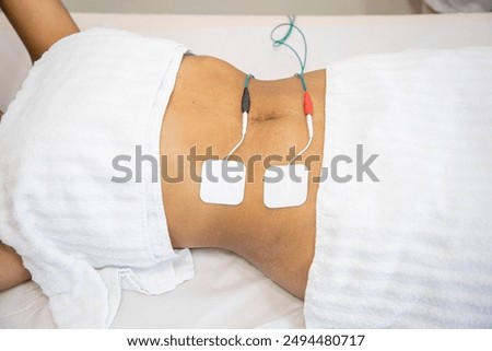 Getting myostimulation procedure of abdominal area for reducing excess weight