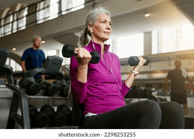 Getting old is not a worry when you this fit. Portrait of a senior woman working out with weights at the gym. - Powered by Shutterstock