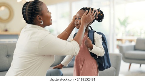 Getting ready, morning and a mother with a child for school, leaving kiss and talking in the living room. Happy, speaking and an African mom helping a girl with a backpack in a house for kindergarten - Powered by Shutterstock