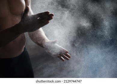 Getting Ready To Perform. A Cropped View Of A Male Gymnast Dusting His Hands With Chalk.