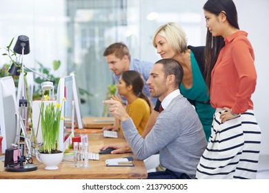 Getting A Second Opinion. Shot Of A Large Group Of Coworkers In The Office.