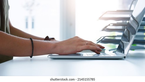 Getting Straight Back To Work. Cropped Shot Of An Unrecognizable Businesswoman Typing On Her Laptop Inside Of The Office At Work.