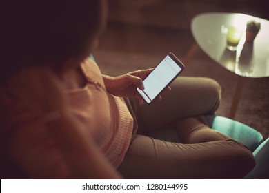 Getting The Weekend Off To A Wireless Start. African American Woman At Home Using Phone. Close Up. Focus On Hand.