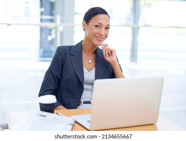 Getting Work Done. A Young Ethnic Businesswoman Using Her Laptop.