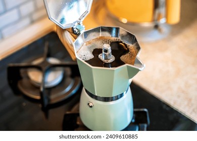 Geyser coffee maker with coffee drink on home kitchen stove in the morning - Powered by Shutterstock