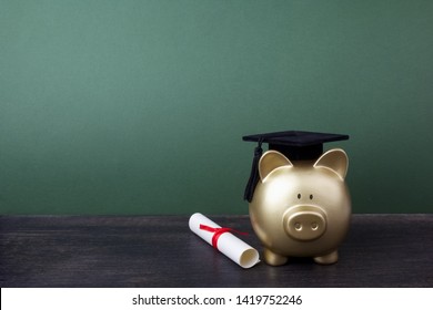 Gfold Piggy Bank With A Grad Cap And Diploma In Front Of Green Chalkboard. Education Scholarship