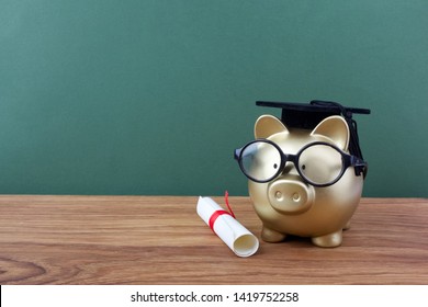 Gfold Piggy Bank With A Grad Cap And Diploma In Front Of Green Chalkboard. Education Scholarship