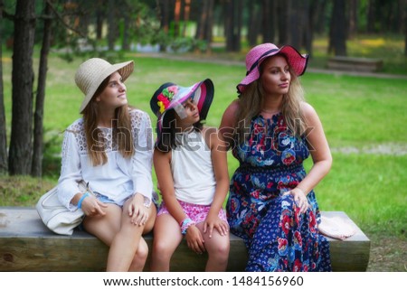Ggirl,  teenager and a woman enjoy a nice sunny day in a pine forest. 