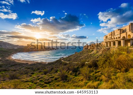 Ghajn Tuffeha, Malta - Beautiful sunset at Ghajn Tuffieha beach on a lovely summer day with beautiful sky and clouds
