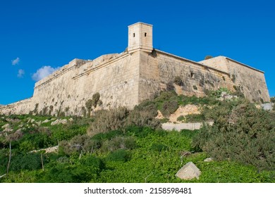 GHAJNSIELEM GO, MALTA - Dec 13, 2021: Watch tower on the walls ofFort Chambray, in Gozo, Malta, fortress built by the Order of St John to protect the coastline at Xatt l-Ahmar, Ghajnsielem
