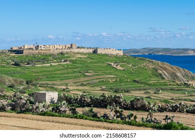 GHAJNSIELEM GOZO, MALTA - Dec 13, 2021: Panoramic view of hills and Fort Chambray, in Gozo, Malta, fortress built by Order of St John to protect the coastline at Xatt l-Ahmar, Ghajnsielem