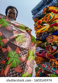 Ghana Woman Looking At Various Fabrics In Accra Market Located In Ghana West Africa.