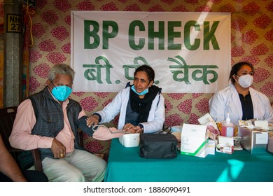 Ghaziabad, Uttar Pradesh, India- December 5  2020: A Doctor Checking Blood Pressure Of A Farmer In Mask. Doctor Health Check Up Camp At Farmers Protest Area Near Ghazipur Border