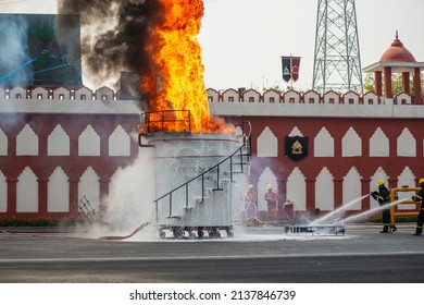 Ghaziabad, Uttar Pradesh, India-March 6 2022: Firefighter With Advanced Firefighting Technology Spraying Chemical On Crude Oil Tank, Fire Service Man Demonstrate Their Industrial Skill.