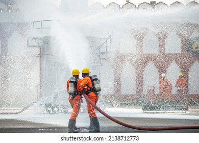 Ghaziabad, Uttar Pradesh, India-March 6 2022: Firefighter With Advanced Firefighting Gear Spraying Chemical On Crude Oil Tank, Demonstrate Their Skill 