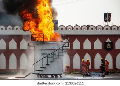 Ghaziabad, Uttar Pradesh, India-March 6 2022: Firefighter With Advanced Firefighting Technology Spraying Chemical On Crude Oil Tank, Fire Service Man Demonstrate Their Industrial Skill.