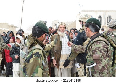 GHAZNI, AFGHANISTAN - February 2011: An Elderly Afghan Man Is Confronted By Two Afghan National Army Soldiers During A Joint Mission Conducted By Polish Task Force White Eagle In Eastern Afghanistan.