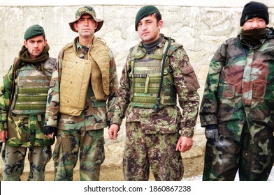 GHAZNI, AFGHANISTAN - February 27, 2011: Afghan National Army Soldiers Wearing Military Body Armor Pose For A Photo In The Snow After A Mission Planned By Polish Task Force White Eagle In The RC East.