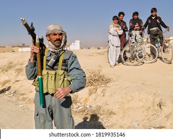 GHAZNI, AFGHANISTAN - NOVEMBER 2010: Afghan National Police Officer Patrols A Village With A Rocket Propelled Grenade Launcher.