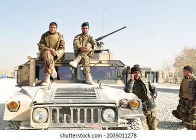 GHAZNI, AFGHANISTAN - November 2010: Afghan National Army (ANA) Soldiers Sitting On And Around One Of Their Military HMMWV (Humvee) Before Going On Patrol In Eastern Afghanistan.