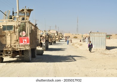 GHAZNI, AFGHANISTAN - November 2010: US And Polish Soldiers With The International Security Assistance Force (ISAF) Task Force White Eagle Patrol The Streets Of A Village In Eastern Afghanistan.