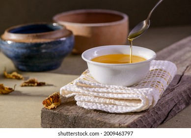 Ghee Butter From India In White Dinnerware Container On Wooden Table.