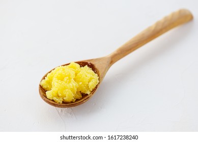 Ghee Butter In A Spoon On A Light Table.