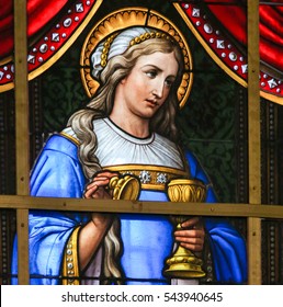 GHENT, BELGIUM - DECEMBER 23, 2016: Stained Glass In Saint Nicholas Church, Ghent, Belgium, Depicting Mary Magdalene And An Allegory On The Suffering Of Jesus.